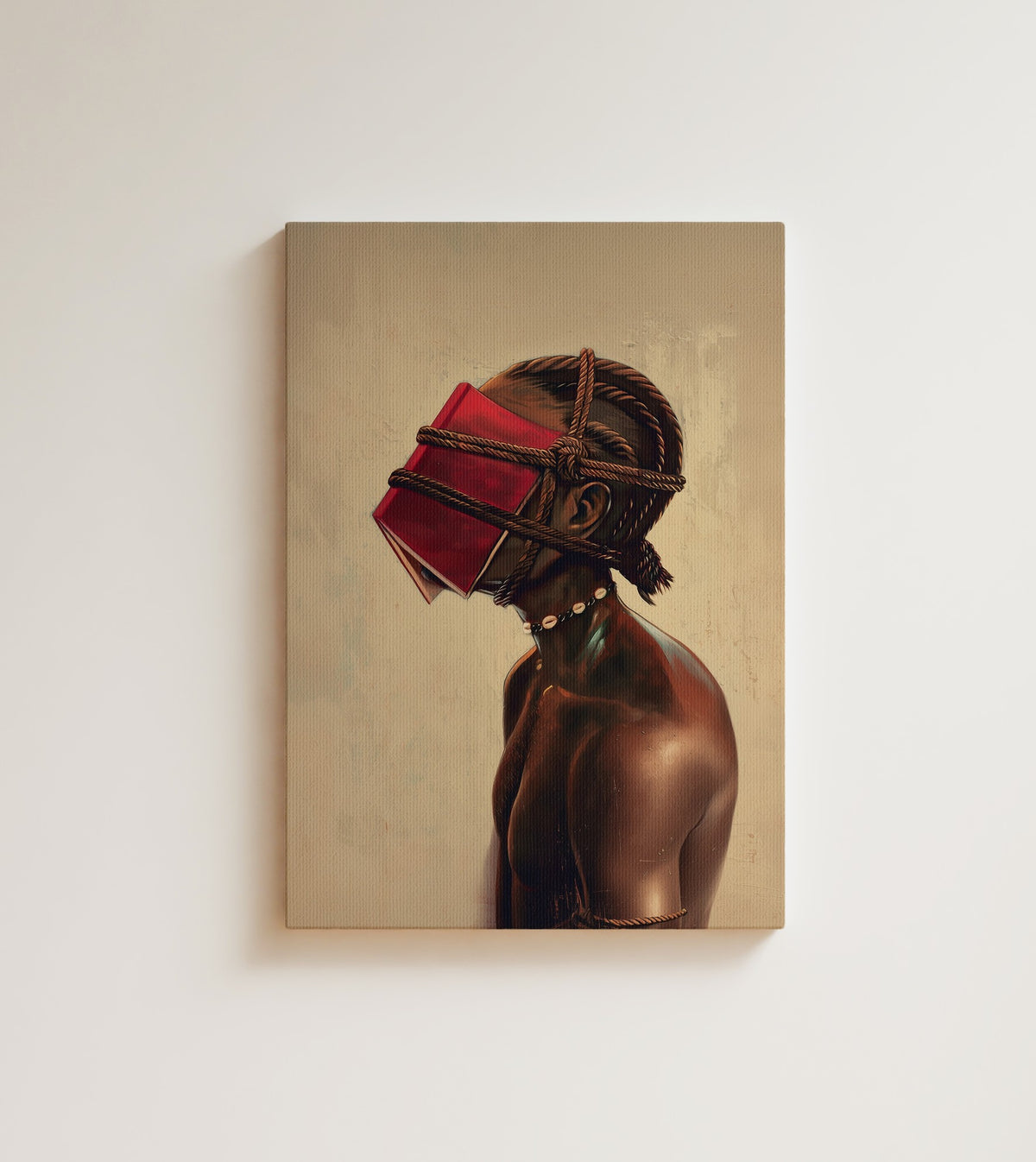 The Reader, Bound: A Black man in profile, a red book bound over his eyes and cowrie shells at his throat. Canvas wall art, shown on a plain wall