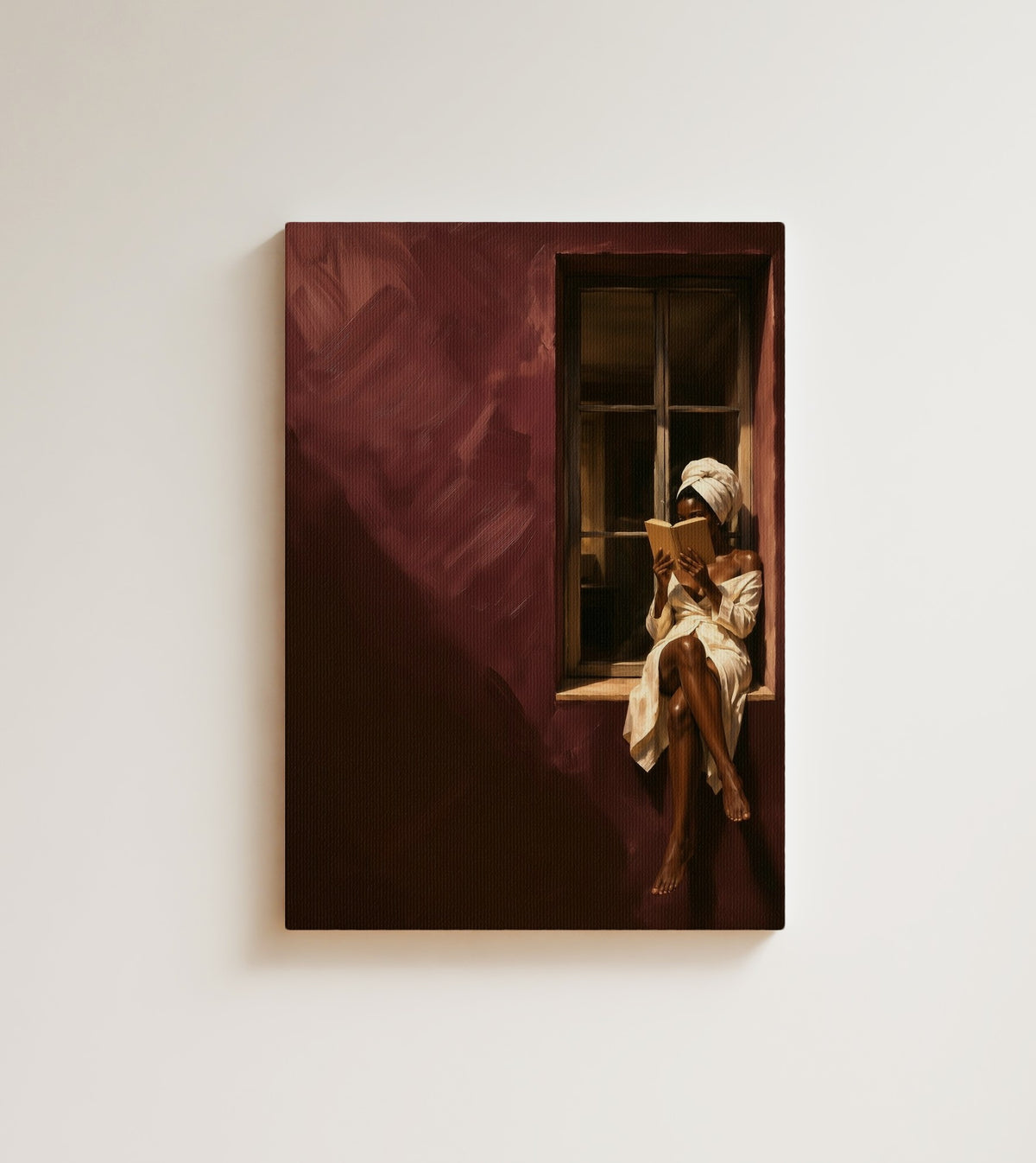 Reader in Burgundy: A woman in a white robe and towel reads on a window sill against a burgundy wall in heavy shadow. Canvas wall art, shown on a plain wall