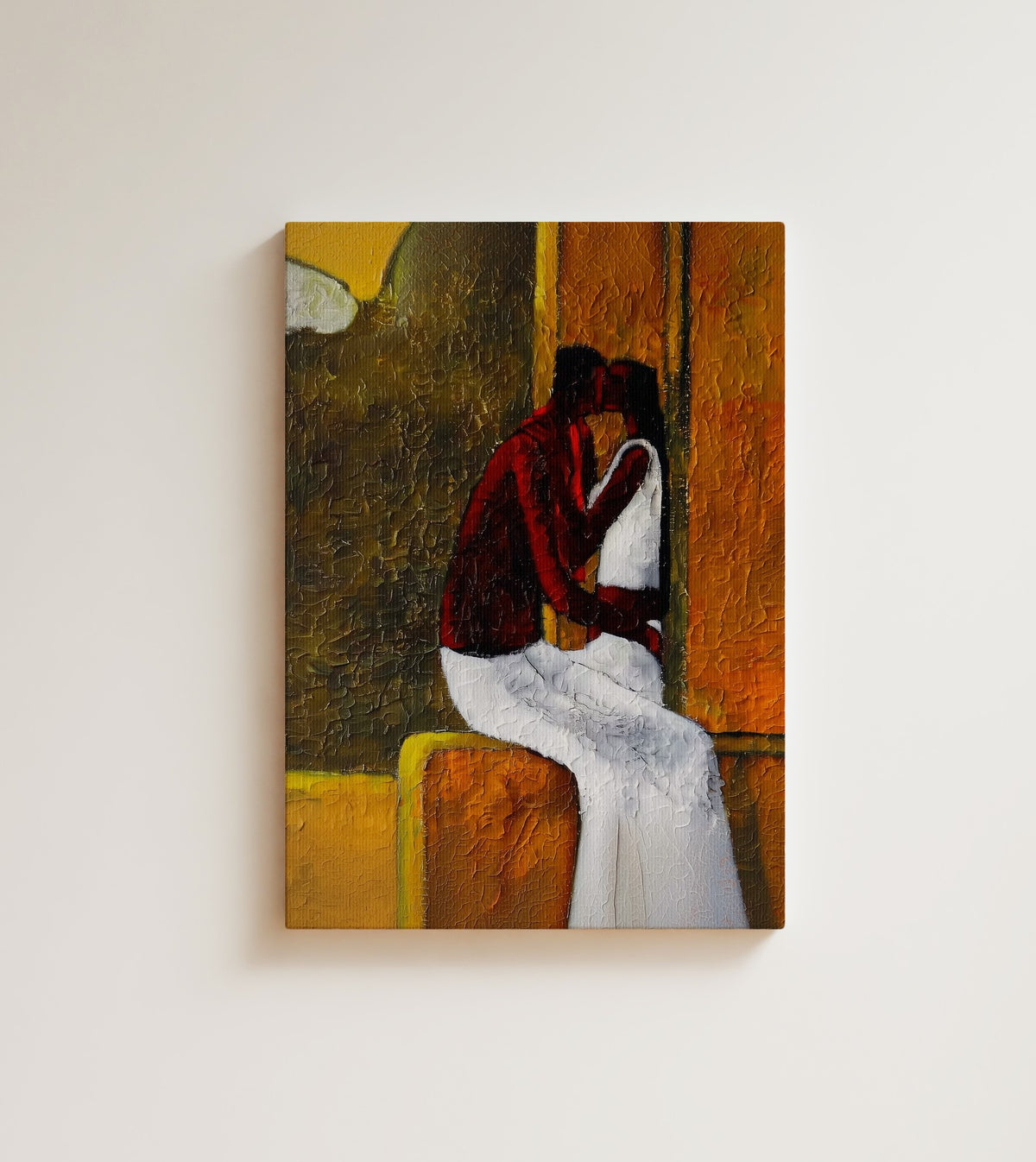 The Stolen Kiss: A Black couple shares a kiss, his red shirt against her white dress. Canvas wall art, shown on a plain wall