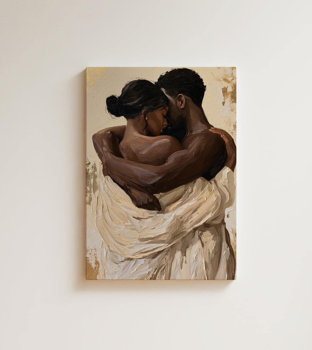 The Embrace: A Black couple holds each other close, draped in cream cloth against a soft rose pink ground. Canvas wall art, shown on a plain wall