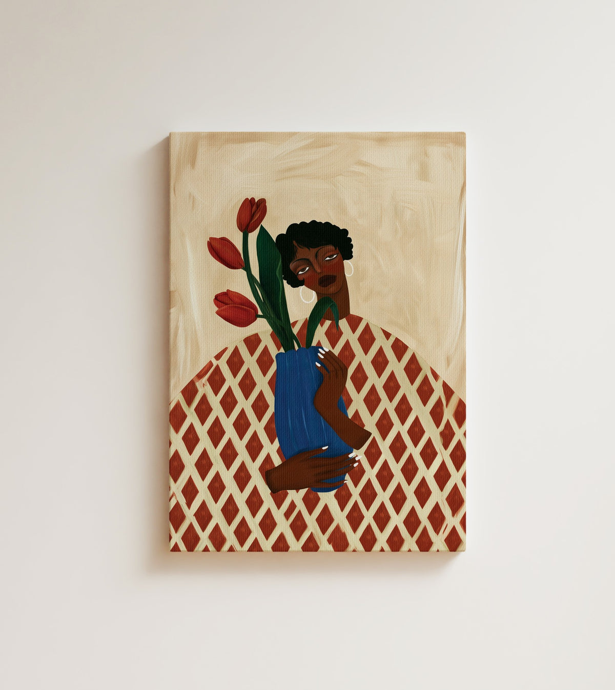 Tulip Hour: A woman with short curls hugs a blue vase of red tulips over a red and cream checkered tablecloth. Canvas wall art, shown on a plain wall