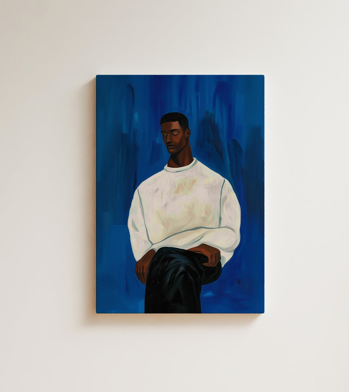 The White Sweater: A young Black man with closed eyes, wrapped in a cream sweater. Canvas wall art, shown on a plain wall