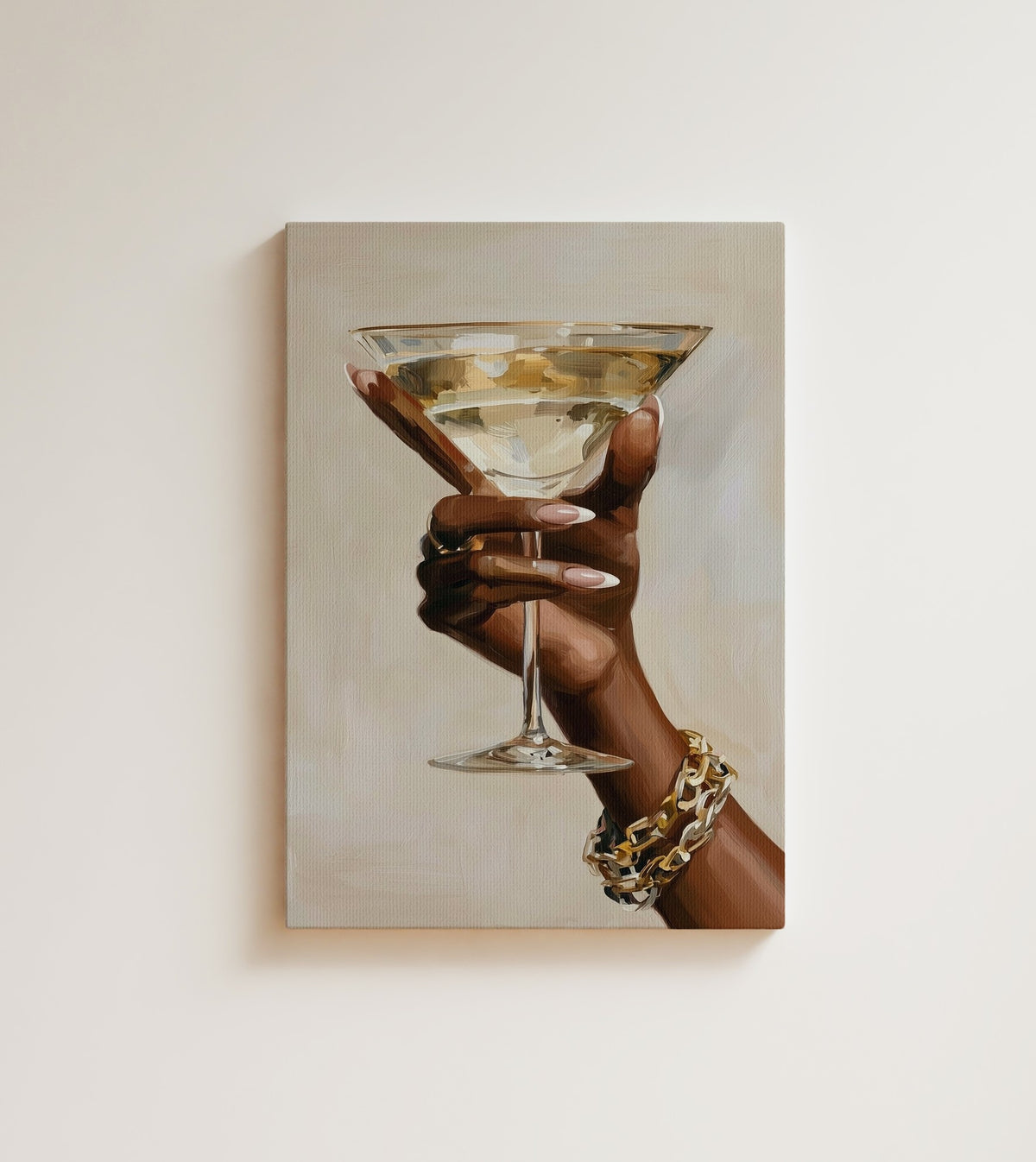 One Last Glass: A hand with long pink nails and a gold chain bracelet lifts a martini against a warm cream background. Canvas wall art, shown on a plain wall