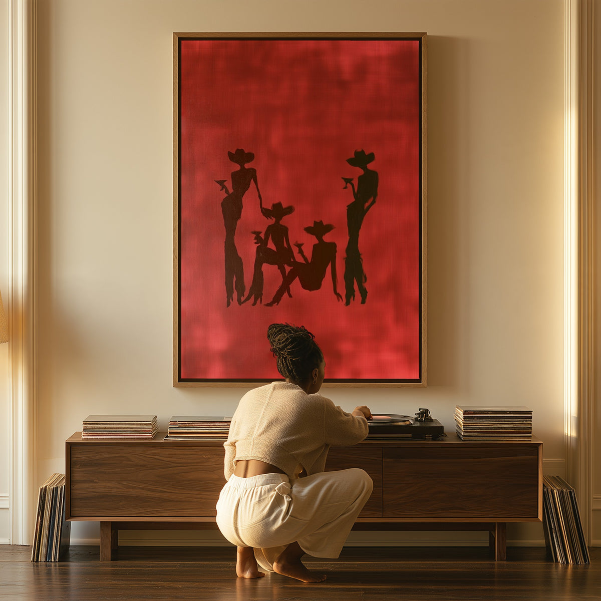 Cowgirls at Dusk canvas above a console table, a woman beside it
