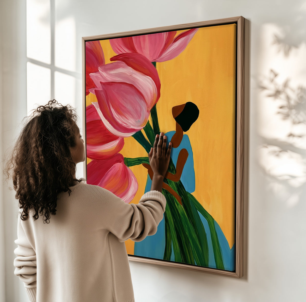 Carrying Spring framed canvas, a woman hanging it on a sunlit wall