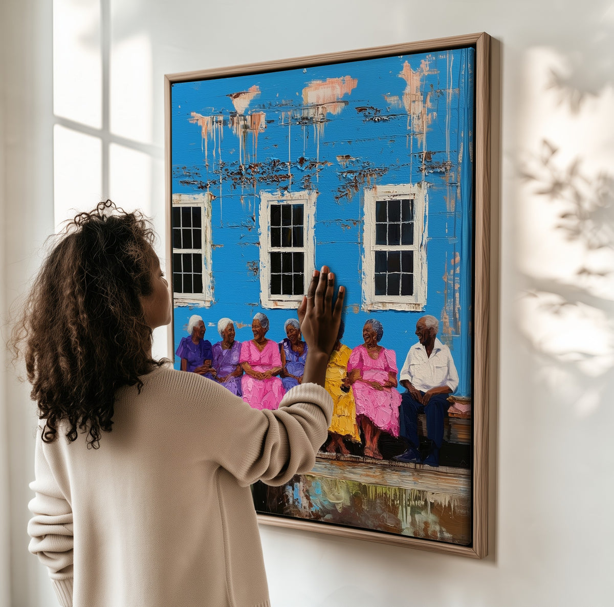The Elders' Bench framed canvas, a woman hanging it on a sunlit wall