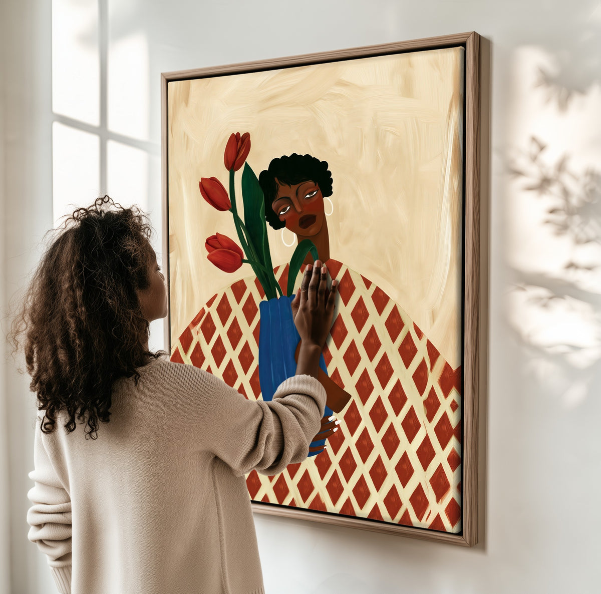 Tulip Hour framed canvas, a woman hanging it on a sunlit wall