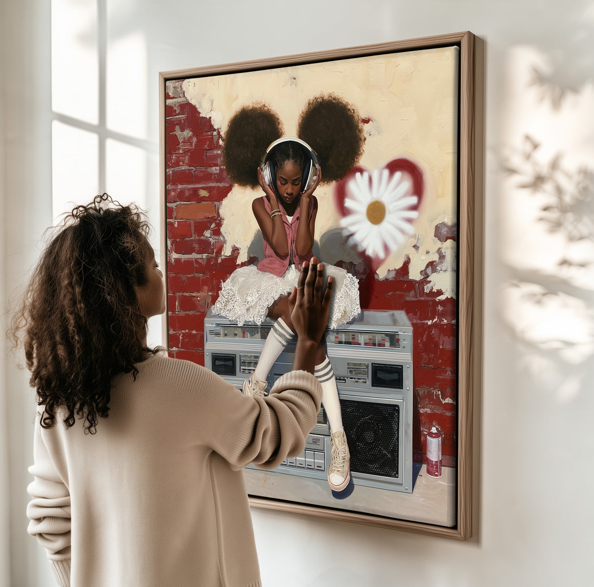 Girl with Headphones framed canvas, a woman hanging it on a sunlit wall