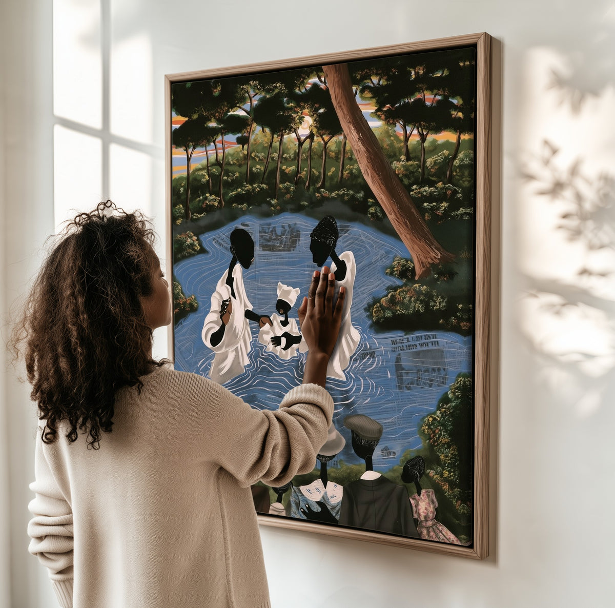 The River Baptism framed canvas, a woman hanging it on a sunlit wall