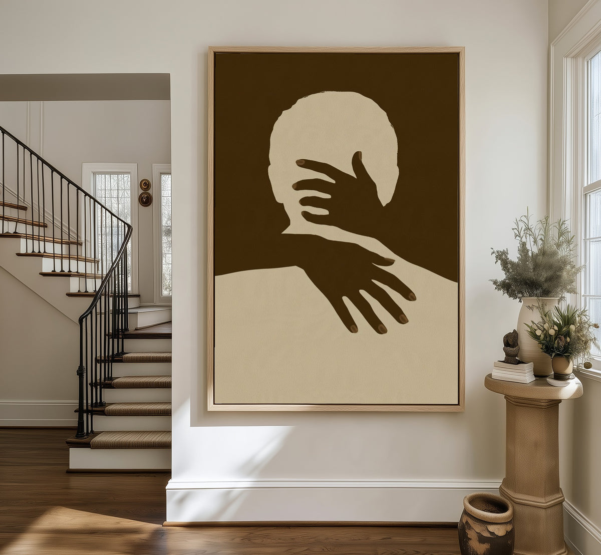 Held framed canvas in an entryway by the stairs