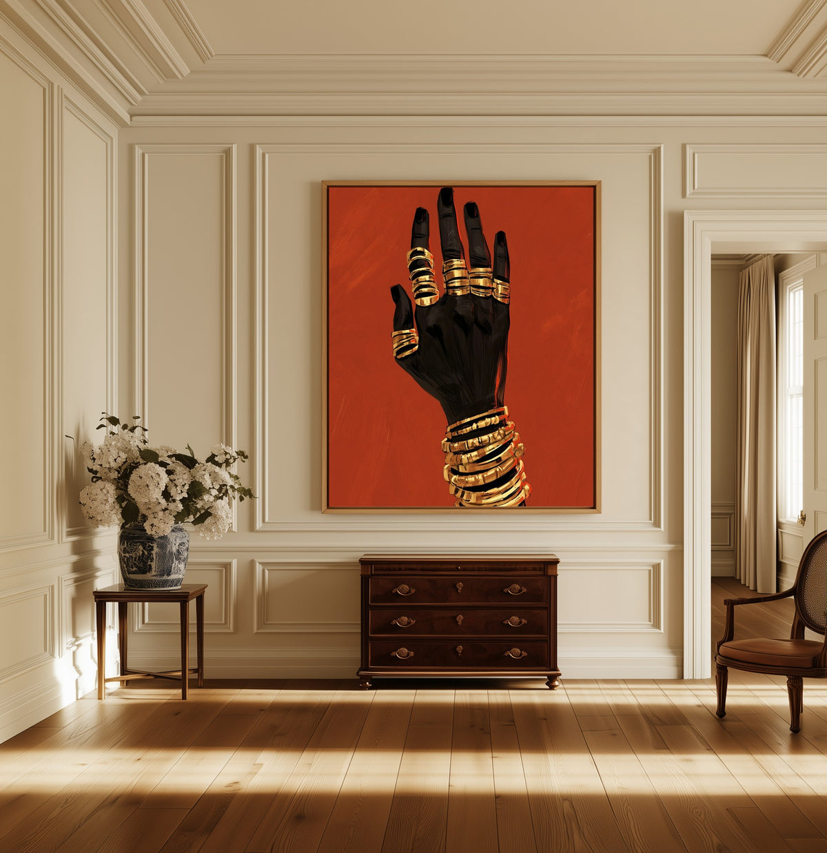 Hand in Gold canvas above a dark wood chest in a hallway