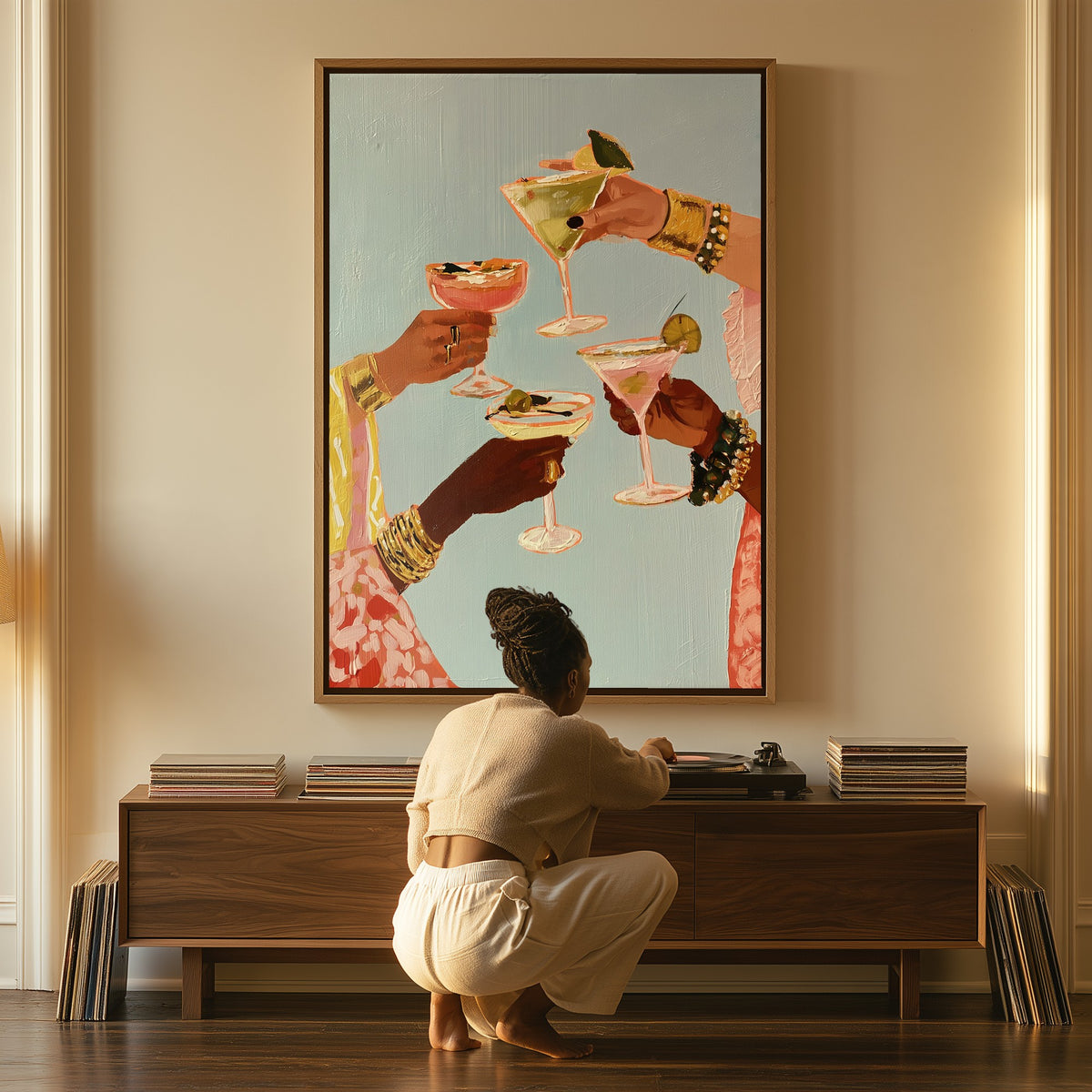 A Toast at Five canvas above a console table, a woman beside it