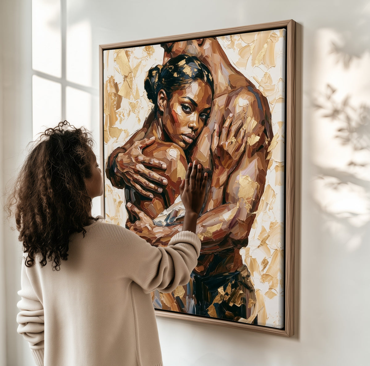Held Close framed canvas, a woman hanging it on a sunlit wall