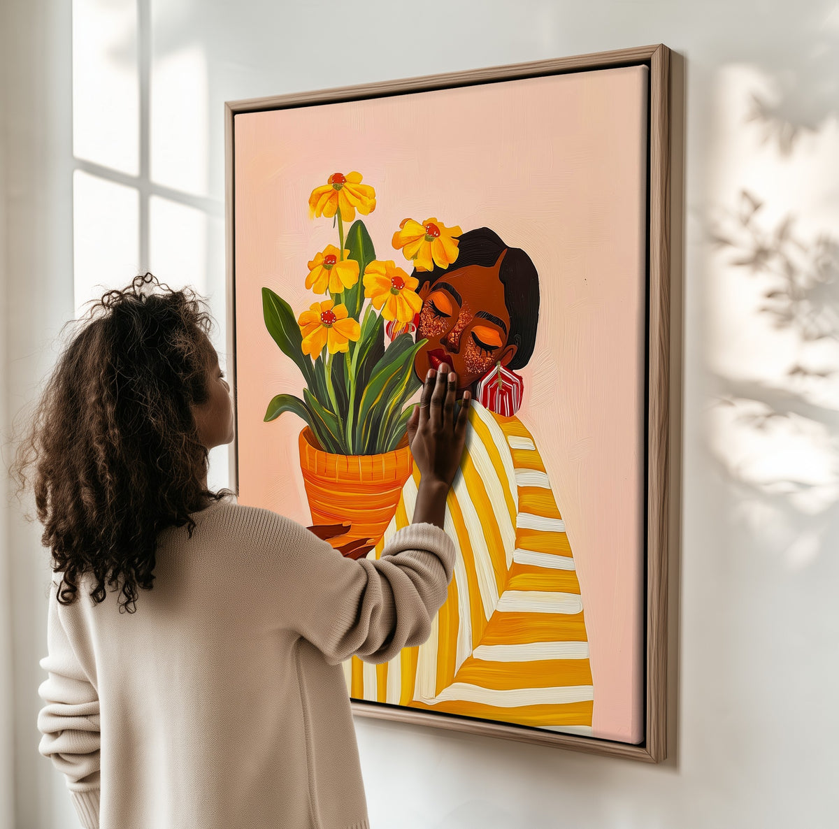 Woman with Marigolds framed canvas, a woman hanging it on a sunlit wall