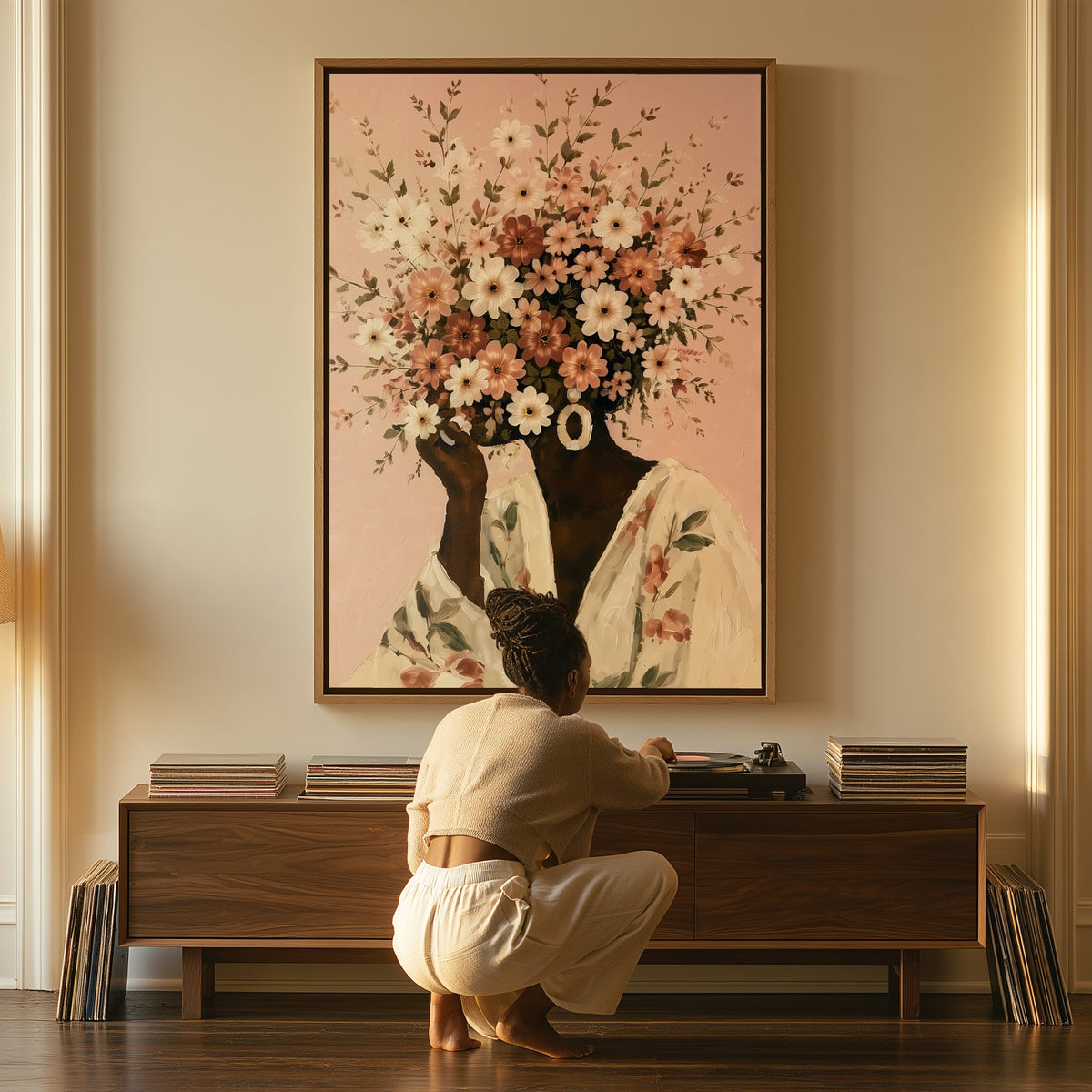 Full Bloom canvas above a console table, a woman beside it