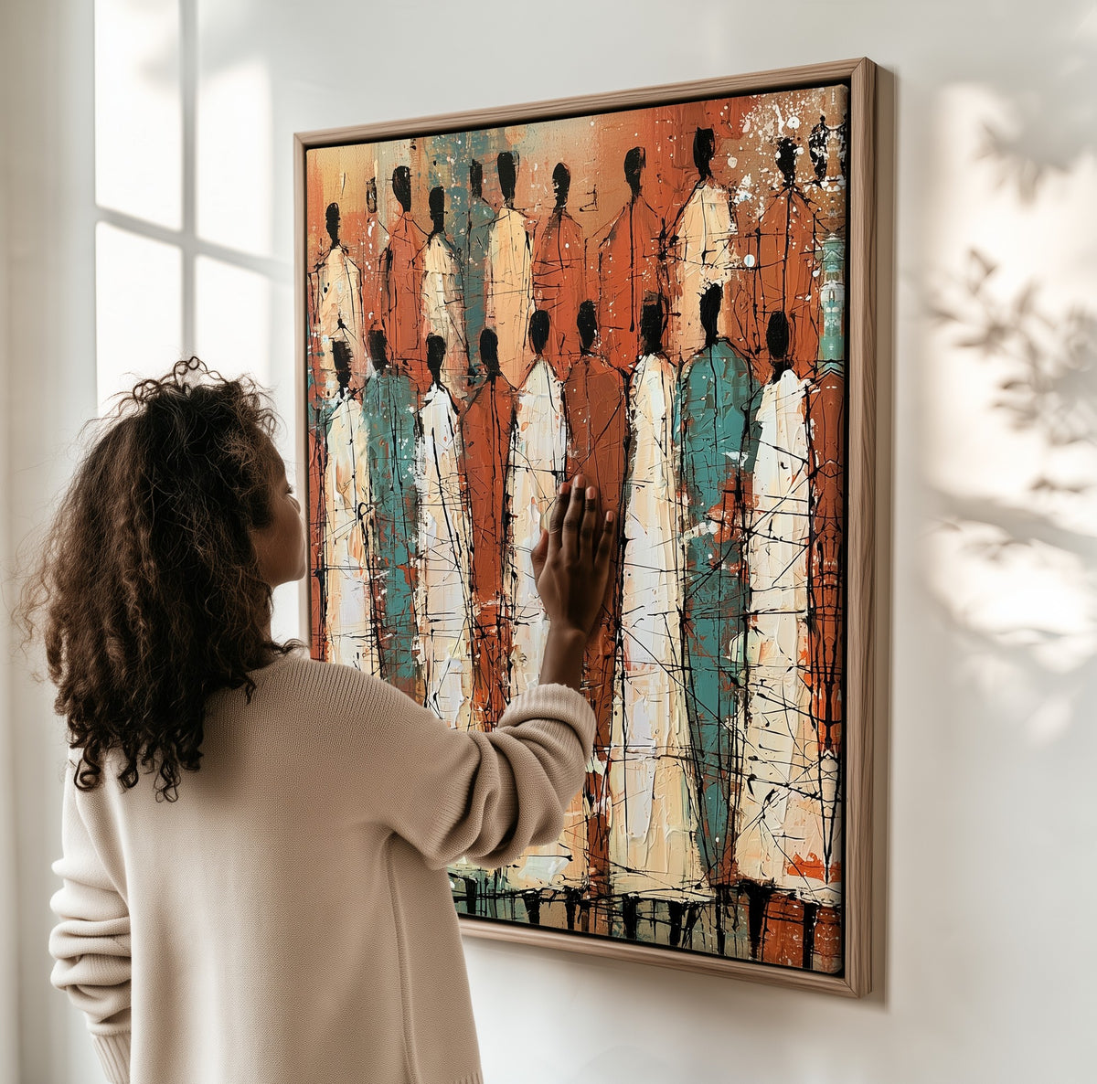 Standing Chorus framed canvas, a woman hanging it on a sunlit wall
