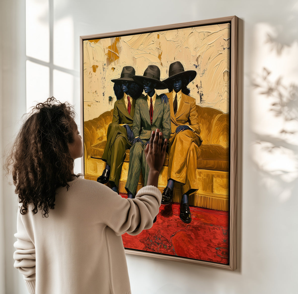 Three on the Sofa framed canvas, a woman hanging it on a sunlit wall